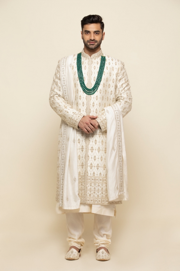 Photo of Unique groom look with blue sherwani and gold accessories